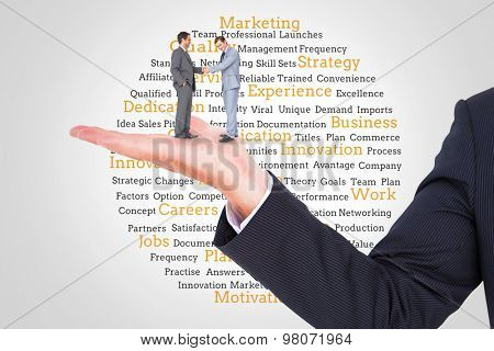 Businessmen shaking hands against group of yellow marketing terms