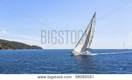 Sailing. Ship yachts with white sails in the Sea. Luxury boats.