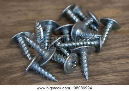 Screws On Wooden Background