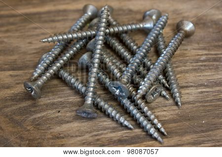 Screws On Wooden Background