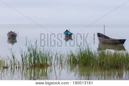 Old rowboats on the lake at sunset