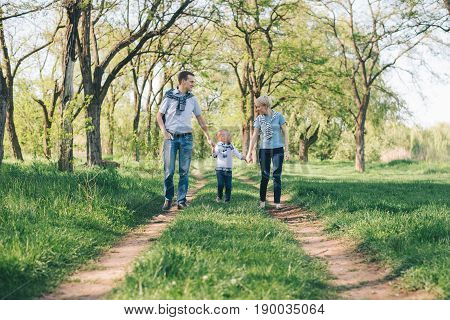 happy young family have fun in prak while walking