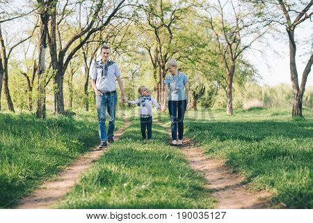 happy young family have fun in prak while walking