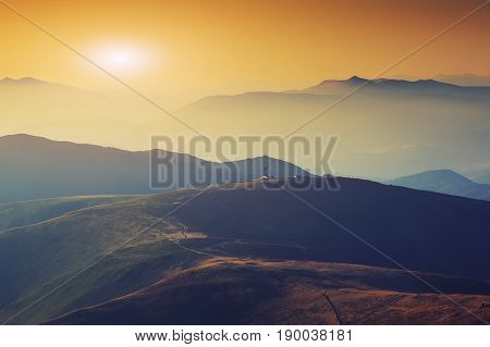 Silhouettes of the mountain hills at sunset. mountain cascade