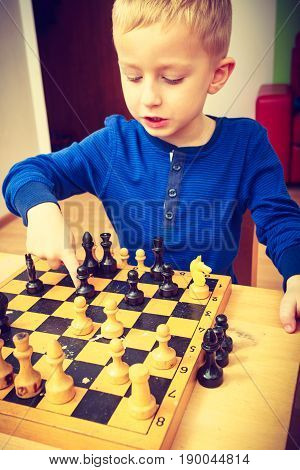 Young Kid Boy Playing Chess Having Fun