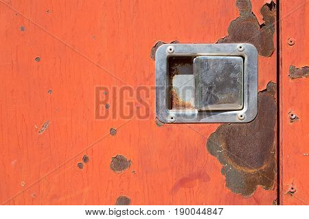 Old worn metal surface with orange paint. Rusty metal texture. Metal sheet with rust and worn paint. Background. Metal. Wall. Floor.