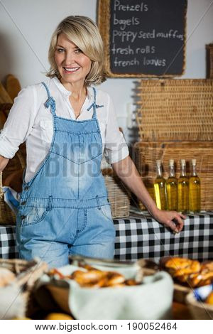 Female staff standing at bakery section in supermarket