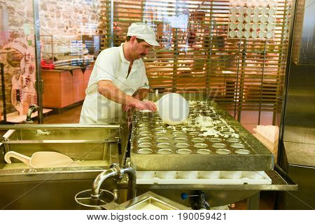 Cheesemaker Preparing The Cheese In A Show Dairy At Engelberg