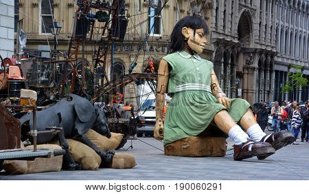 MONTREAL QUEBEC CANADA 19 05 17: The little giant girl sleeping in Place d'arme in old Montreal for the 375e anniversary of the city, by Royal De Luxe company Nantes France