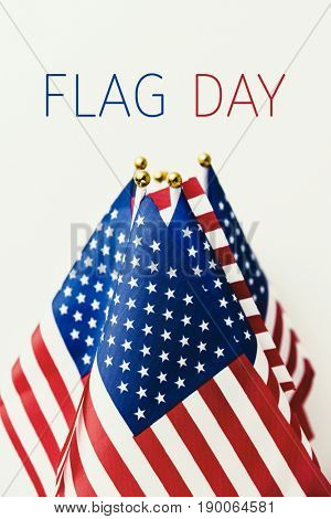 the text flag day and many flags of the United States against an off-white background