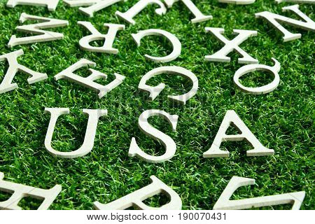 USA wording placed on artificial green grass background (Concet for United States of America)