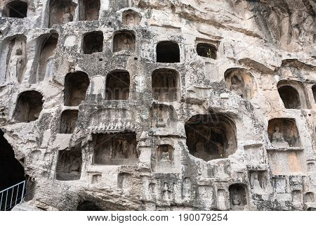 Carved Figures And Caves In Wall Of West Hill