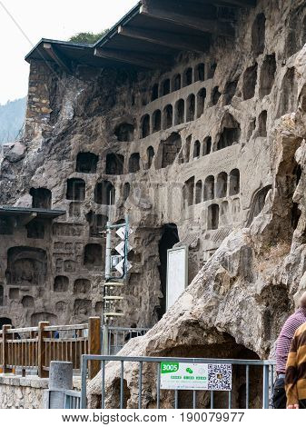 Tourists Near Caves In Longmen Grottoes