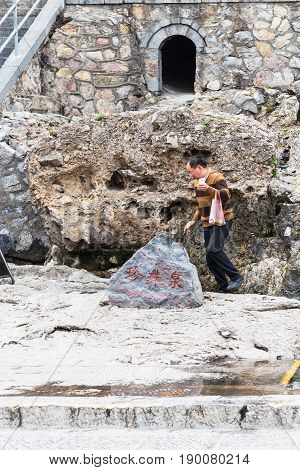 Visitor Near Monuments In Longmen Grottoes
