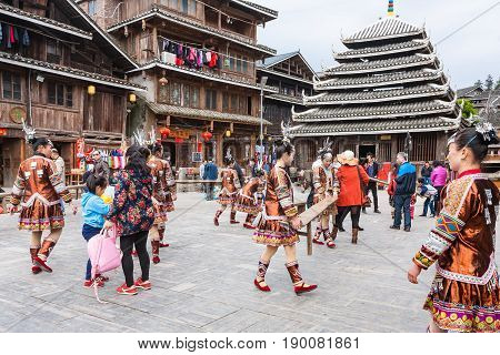 Tourists And Actors On Square Of Folk Centre