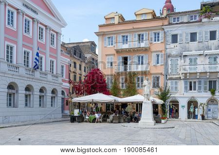 KERKYRA, GREECE - MAY 23: Tourists in cafes in front of town hall on May 23, 2017 in Kerkyra, Corfu island in Greece.