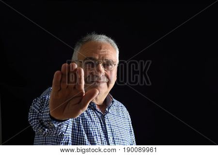 Man with stop sign on black background