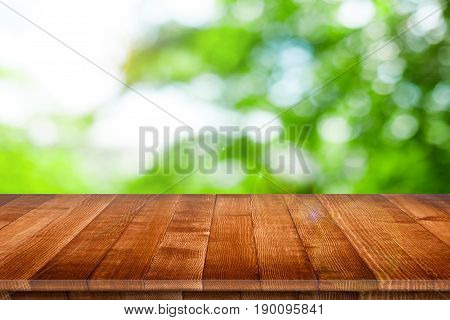 Empty wooden table for product placement or montage with focus to table top in the foreground, with white background. Wooden board empty table perspective.