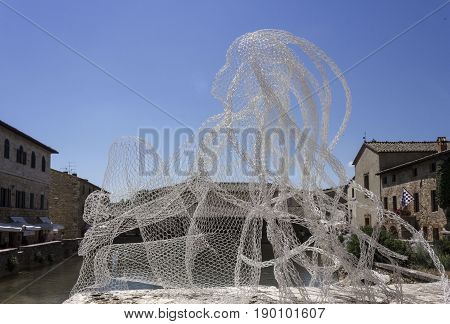 BAGNO VIGNONI, ITALY - JUNE 3 2017: Metal Wires transparent sculpture by Italian sculptress Daniela Capaccioli in Bagno Vignoni medieval town in Tuscany Italy