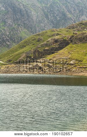 LLyn Llydaw lake on Snowdon with ruins of the Brittania Copper Mine on the far bank. Snowdonia Wales United Kingdom.