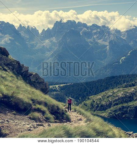 Trekker walking a picturesque mountain trail. Brenta group in Italy.