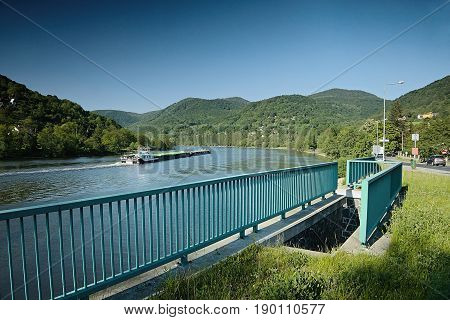 Sebuzin Czech republic - May 19 2017: cargo ship sails on european river Labe near Sebuzin village in spring czech landscape