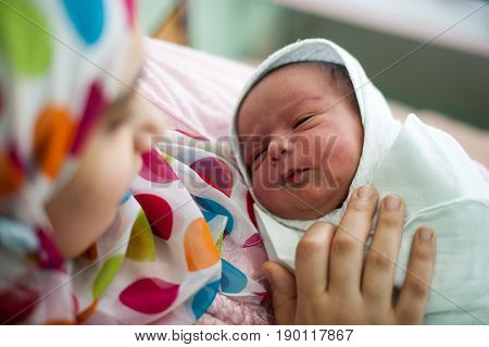 Arabic Muslim mother carrying her child in hospital bed immediately after delivery