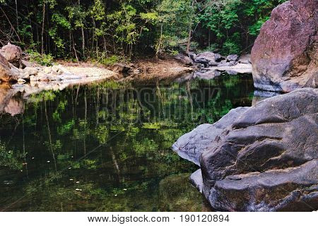 Small mountain stream in the shade of the tropical forest Mu Koh Chang National Park, Thailand. View from the trail to Khlong Phlu waterfall. Natural background.