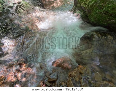A shot taken from above a beautiful cascading waterfall at the Blue Hole in East Tennessee, USA.