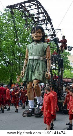 MONTREAL QUEBEC CANADA 19 05 17: The little giant girl walking in the street of Montreal for the 375e anniversary of the city, by Royal De Luxe company Nantes France