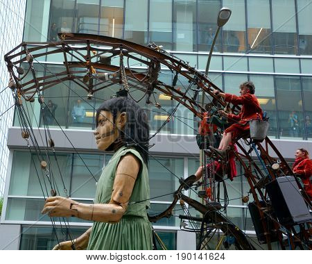 MONTREAL QUEBEC CANADA 19 05 17: The little giant girl walking in the street of Montreal for the 375e anniversary of the city, by Royal De Luxe company Nantes France
