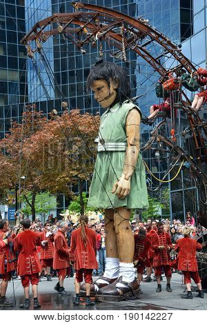 MONTREAL QUEBEC CANADA 19 05 17: The little giant girl walking in the street of Montreal for the 375e anniversary of the city, by Royal De Luxe company Nantes France