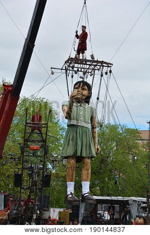 MONTREAL QUEBEC CANADA 19 05 17: The little giant girl walking in the street of Montreal for the 375e anniversary of the city, by Royal De Luxe company Nantes France