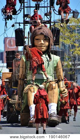 MONTREAL QUEBEC CANADA 19 05 17: The little giant girl walking in the street of Montreal for the 375e anniversary of the city, by Royal De Luxe company Nantes France