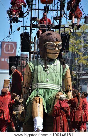 MONTREAL QUEBEC CANADA 19 05 17: The little giant girl walking in the street of Montreal for the 375e anniversary of the city, by Royal De Luxe company Nantes France
