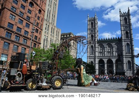 MONTREAL QUEBEC CANADA 19 05 17: The little giant girl walking in the street of Montreal for the 375e anniversary of the city, by Royal De Luxe company Nantes France