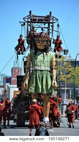 MONTREAL QUEBEC CANADA 19 05 17: The little giant girl walking in the street of Montreal for the 375e anniversary of the city, by Royal De Luxe company Nantes France