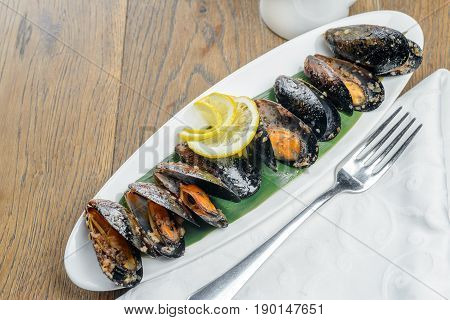 Oysters with lemon on long white plate
