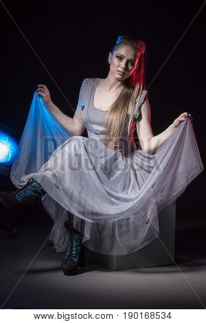 Actress In A Grey Dress On A Dark Stage