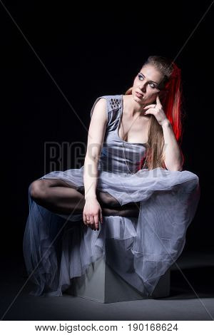 Actress In A Grey Dress On A Dark Stage