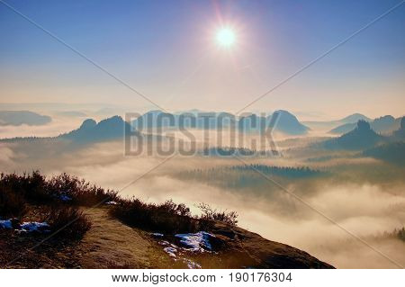 Dreamy Misty Landscape. Majestic Mountain Cut The Lighting Mist. Deep Valley Is Full Of Colorful Fog