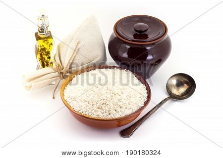 The Composition Of Rice Groats In A Clay Pial Next To A Clay Pot And A Copper Spoon,