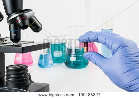Analysis of medicaments in laboratory. Medical Research and diseases Science. Microscope and laboratory vessels