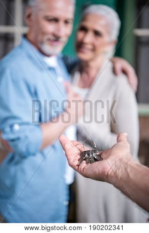 Saleman Giving Keys Of New House To New Owners, Selective Focus