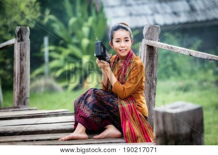 Thailand young beautiful woman listen to transistor radio a have happiness joyful