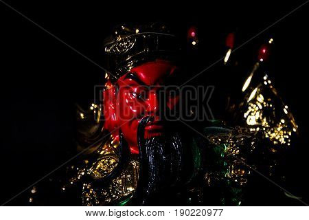 Kwnao Guanyu Red face on background black color.