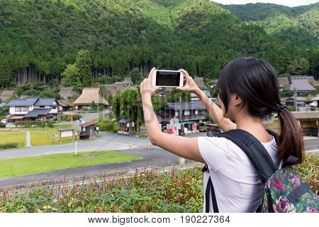 Woman taking photo in Miyama