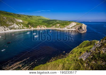 british seaside - summer holiday destination - Lulworth cove on Jurassic coast in southern Devon, UK