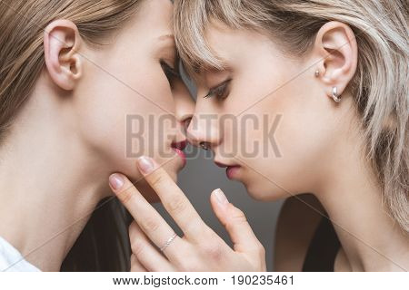 Close Up Portrait Of Sensual Lesbian Couple Kissing With Eyes Closed