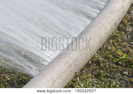water leaking from hole in a hose.